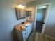 Bathroom featuring a granite vanity with built in sink, mirror cabinet and view to the bedroom at 3541 65Th Avenue E Cir, Sarasota, FL 34243