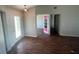 Sun-drenched entryway featuring a decorative glass door and view into an adjacent room through a decorative pink door at 3541 65Th Avenue E Cir, Sarasota, FL 34243