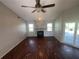 Spacious living room with wood-look flooring, fireplace, and access to a screened patio at 3541 65Th Avenue E Cir, Sarasota, FL 34243