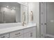 Modern bathroom with white cabinets, quartz countertops, and a view of a tiled shower at 3605 W Dale Ave, Tampa, FL 33609