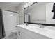 This bathroom has a double sink, white cabinets, and a shower with a bathtub at 3605 W Dale Ave, Tampa, FL 33609