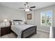 This bedroom has a ceiling fan, a window with shutters, and carpeted floors at 3605 W Dale Ave, Tampa, FL 33609