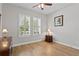 Bright bedroom with hardwood floors, plantation shutters, and natural light at 3605 W Dale Ave, Tampa, FL 33609