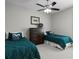 Comfortable bedroom with two twin beds, dark wood dresser and neutral colored carpet at 3605 W Dale Ave, Tampa, FL 33609