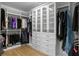 Spacious walk-in closet with custom shelving and glass-front cabinets at 3605 W Dale Ave, Tampa, FL 33609