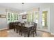 Well-lit dining room with a wooden table, seating for eight, large windows, and hardwood floors at 3605 W Dale Ave, Tampa, FL 33609