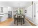 Spacious dining room with hardwood floors, a large table, seating for eight, and lots of natural light at 3605 W Dale Ave, Tampa, FL 33609
