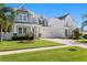 Charming two-story home features a manicured lawn and covered front porch, enhancing its curb appeal at 3605 W Dale Ave, Tampa, FL 33609