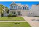 Charming two-story home features a manicured lawn and covered front porch, enhancing its curb appeal at 3605 W Dale Ave, Tampa, FL 33609
