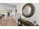 Elegant foyer with hardwood floors, a round decorative mirror, and a view of the adjacent dining area at 3605 W Dale Ave, Tampa, FL 33609