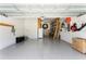 This garage has an epoxy floor, a door, shelves, and a ladder at 3605 W Dale Ave, Tampa, FL 33609