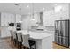 Beautiful kitchen with a central island, white cabinetry, and stainless steel appliances, perfect for entertaining at 3605 W Dale Ave, Tampa, FL 33609