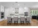 Bright, modern kitchen with a center island, pendant lighting, and ample cabinet space at 3605 W Dale Ave, Tampa, FL 33609