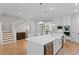 Open-concept kitchen boasts white cabinets, stainless steel appliances, a large island, and a wine fridge at 3605 W Dale Ave, Tampa, FL 33609