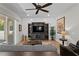 Living room featuring a ceiling fan, shiplap accent wall, and sliding glass doors to the outside at 3605 W Dale Ave, Tampa, FL 33609