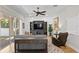 Living room featuring a ceiling fan, media center, shiplap accent wall, and sliding doors at 3605 W Dale Ave, Tampa, FL 33609