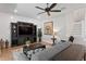 Spacious living room featuring hardwood floors, a ceiling fan and a built-in entertainment center at 3605 W Dale Ave, Tampa, FL 33609