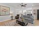 Cozy living room with hardwood floors, decorative rug, comfortable seating, and view into the kitchen at 3605 W Dale Ave, Tampa, FL 33609