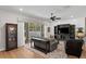 Living room with a ceiling fan, shiplap accent wall, media center, and sliding glass doors at 3605 W Dale Ave, Tampa, FL 33609