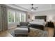 Serene main bedroom with plantation shutters, ceiling fan, and a sitting area at 3605 W Dale Ave, Tampa, FL 33609