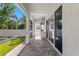 Outdoor kitchen with stainless grill, hood, sink, brick pavers, and screened lanai overlooking manicured yard at 3605 W Dale Ave, Tampa, FL 33609