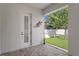 Screened lanai with a door to the house and a view of the green backyard with a playset at 3605 W Dale Ave, Tampa, FL 33609