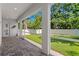 Spacious screened lanai with brick pavers offers a peaceful view of the lush, green, and well-manicured backyard at 3605 W Dale Ave, Tampa, FL 33609