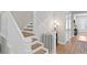 Elegant staircase with wooden steps, white railings, and hardwood floors at 3605 W Dale Ave, Tampa, FL 33609