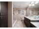 Modern bathroom with a tiled walk-in shower, vanity with sink, and ample storage cabinets at 3687 Imperial Ridge Pkwy, Palm Harbor, FL 34684