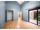 Bedroom with walk-in closet, an open door, and sliding glass doors leading to patio at 3687 Imperial Ridge Pkwy, Palm Harbor, FL 34684