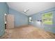 This carpeted bedroom offers lots of natural light from the two windows and a ceiling fan for added comfort at 3687 Imperial Ridge Pkwy, Palm Harbor, FL 34684