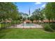 Community pool area featuring a fenced-in pool, covered gazebo and American flag at 3687 Imperial Ridge Pkwy, Palm Harbor, FL 34684