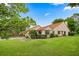 Charming single-story home featuring a well-maintained lawn and manicured landscaping under a blue sky at 3687 Imperial Ridge Pkwy, Palm Harbor, FL 34684