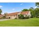 A bright house with a two-car garage, nice landscaping and a manicured lawn under a bright sky at 3687 Imperial Ridge Pkwy, Palm Harbor, FL 34684