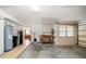 Garage with a workbench, water heater, water filter, and a view into the kitchen at 3687 Imperial Ridge Pkwy, Palm Harbor, FL 34684