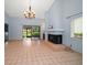 Bright living room boasting tile floors, fireplace, a large window, and a sliding glass door to the patio at 3687 Imperial Ridge Pkwy, Palm Harbor, FL 34684