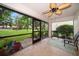 Relaxing screened-in patio with beautiful tile flooring and a ceiling fan for comfortable outdoor living at 3687 Imperial Ridge Pkwy, Palm Harbor, FL 34684
