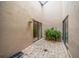 Enclosed brick patio with neutral walls, sliding glass doors, and potted green plants at 3687 Imperial Ridge Pkwy, Palm Harbor, FL 34684