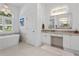 Elegant bathroom featuring a standalone tub, granite countertop vanity, and decorative lighting creating a spa-like experience at 3707 Smoke Hickory Ln, Valrico, FL 33596