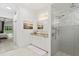 Bright bathroom featuring a double sink vanity, tiled shower, and beach-themed decor creating a serene ambiance at 3707 Smoke Hickory Ln, Valrico, FL 33596