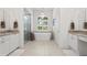 Bright bathroom with double vanity, free standing tub, tiled floors, and a stylish chandelier at 3707 Smoke Hickory Ln, Valrico, FL 33596