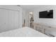 Comfortable bedroom with TV, closet, and access to a bathroom through a doorway, offering convenience and style at 3707 Smoke Hickory Ln, Valrico, FL 33596