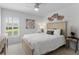 Serene bedroom featuring a comfortable bed with neutral decor and a window with shutters offering natural light at 3707 Smoke Hickory Ln, Valrico, FL 33596