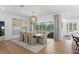 Dining room with modern light fixture and view of the swimming pool outside at 3707 Smoke Hickory Ln, Valrico, FL 33596