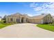 Beautiful single-story home with a three-car garage, manicured lawn, and circular driveway at 3707 Smoke Hickory Ln, Valrico, FL 33596