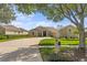 A view of the home from the street, showcasing the well-maintained lawn and mature landscaping at 3707 Smoke Hickory Ln, Valrico, FL 33596