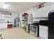 Spacious garage with white cabinets, stainless steel appliances, and ample storage space at 3707 Smoke Hickory Ln, Valrico, FL 33596