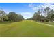 Expansive view of the well-maintained golf course with lush green grass and mature trees at 3707 Smoke Hickory Ln, Valrico, FL 33596