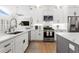 Bright kitchen boasts stainless appliances, a breakfast bar, and white cabinets with elegant marble countertops at 3707 Smoke Hickory Ln, Valrico, FL 33596