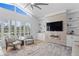 Bright living room with fireplace, built-in shelves, hardwood floors, and large windows with stylish shutters at 3707 Smoke Hickory Ln, Valrico, FL 33596